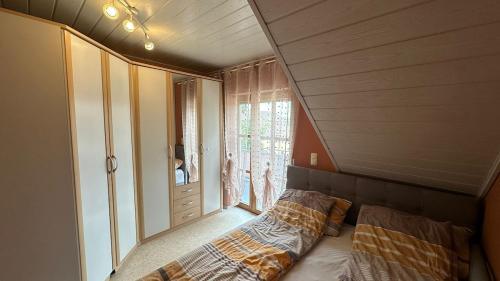 a bedroom with a bed and a large window at Ferienwohnung Nidderau Komfort in Nidderau