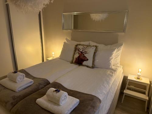 a bedroom with a bed with towels on it at Your Lapland Adventure Base in Rovaniemi