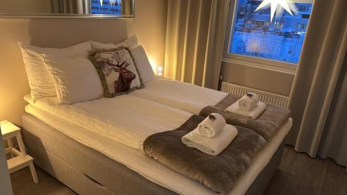 a bedroom with a bed with towels on it at Your Lapland Adventure Base in Rovaniemi