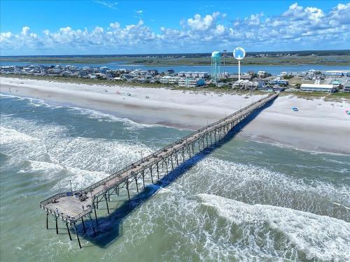 an aerial view of a pier next to a beach at Drift Away in Topsail Beach