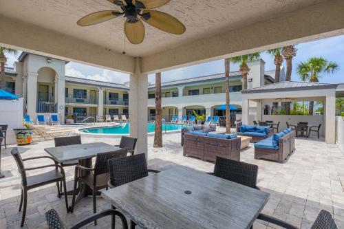 a patio with tables and chairs and a pool at The Ponce St. Augustine Hotel in St. Augustine