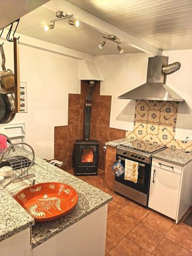 a kitchen with a stove and a stove top oven at Casa 99 in Miranda do Corvo
