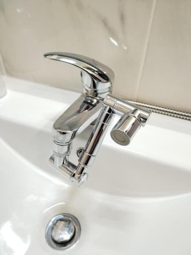 a bathroom sink with a chrome faucet at Studio in Barbéns, Miranda do Corvo - Casa 99 in Miranda do Corvo