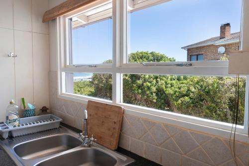 a kitchen with a sink and a window at Leef op Hoop in Boggomsbaai