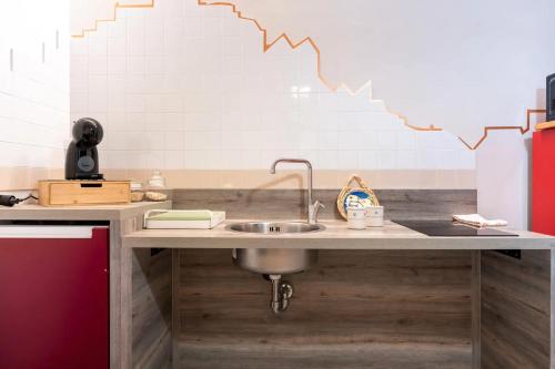 a kitchen with a sink and a graph on the wall at dimora Spine Bianche in Matera
