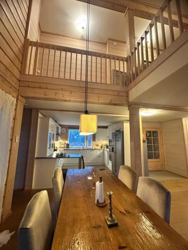 a dining room with a wooden table and chairs at Best Cottage in Ruokolahti