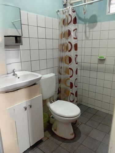 a bathroom with a toilet and a sink at La Esperanza in Puerto Esperanza