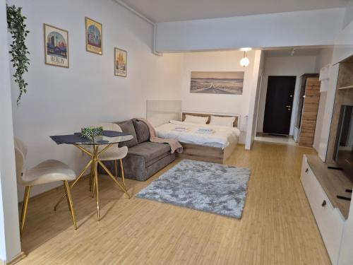 a living room with a couch and a bed at ZenCozy Studio - Free Underground Parking in Bucharest