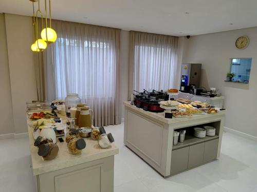 a kitchen with a bunch of food on counters at Hotel Três Caravelas in Fortaleza
