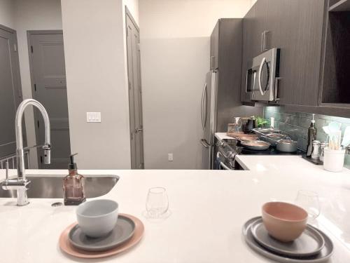 a kitchen counter with two cups and a sink at The Nichols Lux Fort Worth TX Same Day Booking in Fort Worth