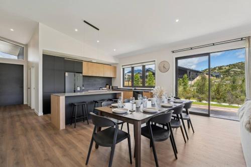 a dining room and kitchen with a table and chairs at Te Maunga Retreat | Views, Space & Near Ski Fields in Frankton