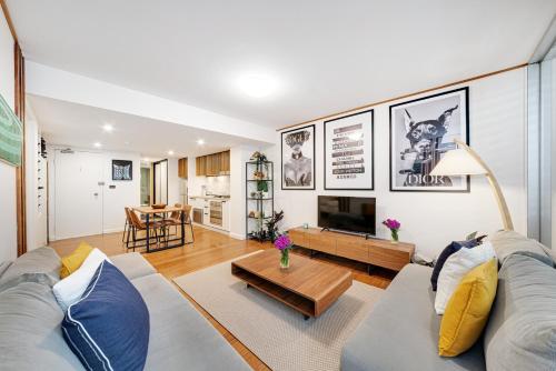 a living room with a couch and a table at DREWS CBD Central Haven 3 min to Oxford St in Sydney