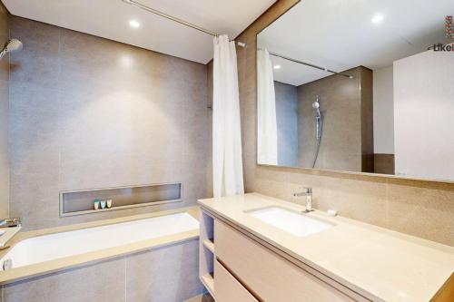 ein Badezimmer mit Waschbecken und Spiegel in der Unterkunft DIRECT BURJ KHALIFA ONLY 2 MINUTES AWAY in Dubai