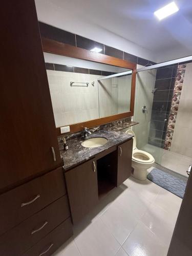 a bathroom with a sink and a toilet at Lumière House in Medellín