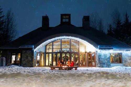 a group of people sitting in front of a building in the snow at 31 GlenEagle in Whistler