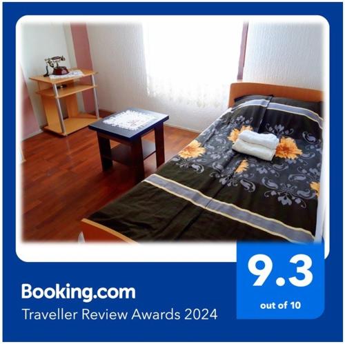 a poster of a bedroom with a bed and a table at Niš Apartman in Niš