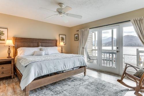 a bedroom with a bed and a balcony at Fire Pit and Boat Dock Lake Chatuge Townhome! in Hiawassee