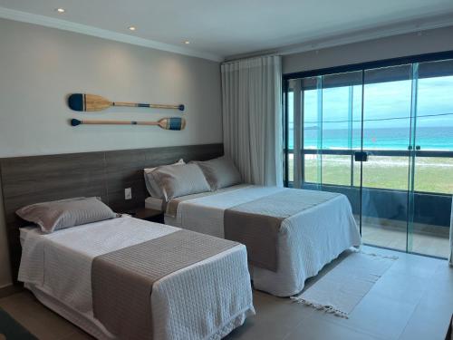 Postel nebo postele na pokoji v ubytování Éolos Loft's - Cabo Frio