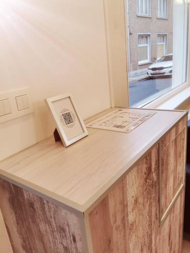 a wooden counter with a book on top of it at Vakantiehuis HA1 in Ieper