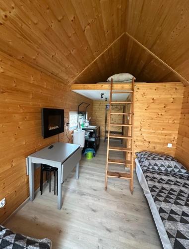 a room with a bunk bed and a desk in a room at Siedlisko Rawka in Doleck