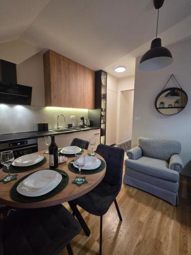 a kitchen and dining room with a table and chairs at Tara Breeze Apartments in Kolašin