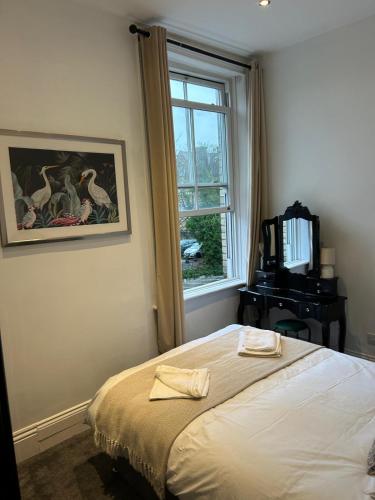 a bedroom with a bed and a window at Station Bridge Collection - Flat 4 in Harrogate
