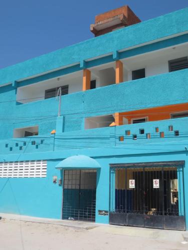 a blue building with a gate in front of it at Mini Vacation in Chelem in Chelem