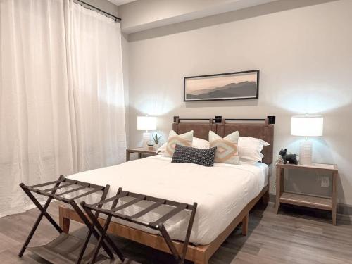 a bedroom with a large bed with white sheets and pillows at The Nichols Estate - Fort Worth - SameDay Bookings in Fort Worth