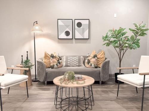 a living room with a couch and a table at The Nichols Estate - Fort Worth - SameDay Bookings in Fort Worth