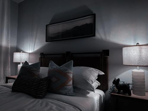 a bedroom with a bed with two lamps and a cat on it at The Nichols Estate - Fort Worth - SameDay Bookings in Fort Worth