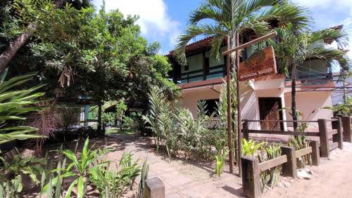 a building with trees and plants in front of it at Pousada Raízes na Vila de Barra Grande in Marau