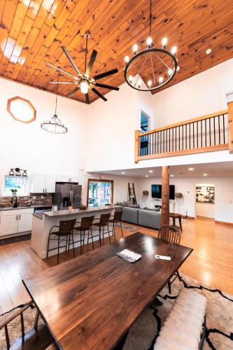 an open living room with a wooden table and chairs at Wolfjaw Lodge in Wilmington