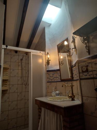 a bathroom with a sink and a mirror at Casa Cuesta Gato in Sedella