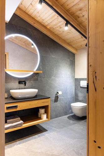 a bathroom with a sink and a toilet at Schulhaus Tirol in Zell am Ziller