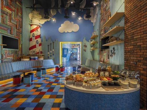 a cafeteria with a table with food on it at Mövenpick Resort & Spa Jimbaran Bali in Jimbaran