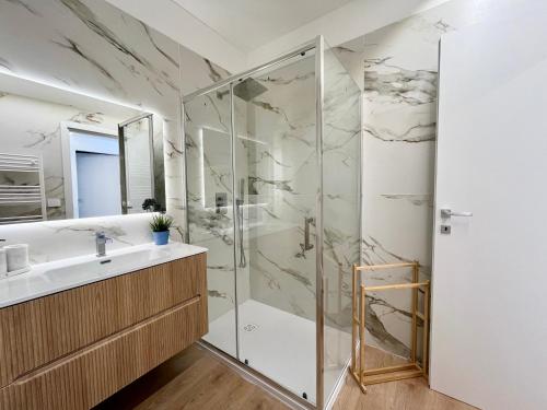 a bathroom with a shower and a sink at Mimosa Seafront Apartment - Free parking Wi-Fi in Varazze