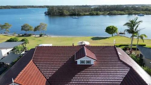 an aerial view of a house with a view of a lake at Crystal Palms - Oceanstays - Riverside in Yamba