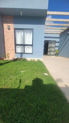 イタポアにあるJenni's Houseの家の前の芝生の影