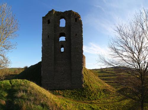 an old building on a grassy hill at The White Horse Inn, Clun in Clun