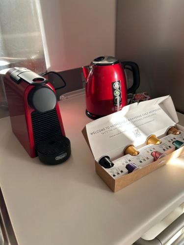 a coffee maker and a toaster on a counter with a box at Larocca Tourist Home 6 Bassano in Bassano del Grappa