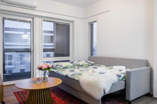 a living room with a bed and a table at Lapland Apartment in Rovaniemi