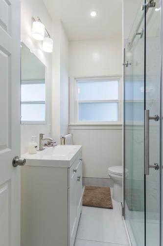 a white bathroom with a sink and a shower at 4 - Berkeley Private Apartment with Parking & Laundry in Berkeley