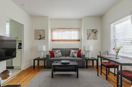 a living room with a couch and a table at 4 - Berkeley Private Apartment with Parking & Laundry in Berkeley