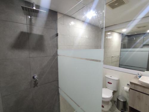 a bathroom with a shower with a toilet and a sink at Apartment on Margarita Island edif Lagunablanca Apto 1201 in Porlamar