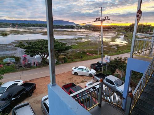 a group of cars parked in a parking lot at ชมวิว บึงโขงหลง in Bung Khong Long