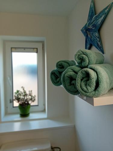 a pile of towels on a shelf next to a mirror at Luxurious Double En-Suite Tralee Town Centre in Tralee
