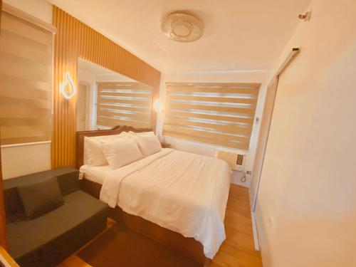 a small bedroom with a bed and a window at MD Suite by Seawind in Davao City