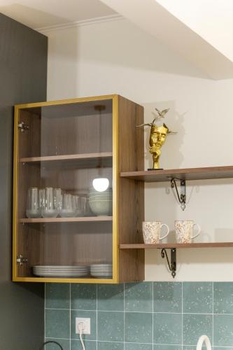 a kitchen with wooden cabinets with dishes in it at PHOS Nest in Serres
