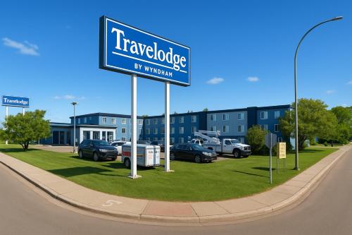a blue street sign in front of a building at Travelodge by Wyndham Regina in Regina