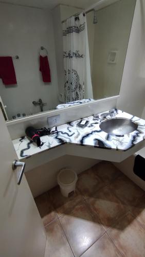 a bathroom with a sink and a mirror at Torre Obelisco - Apart 2 Amb en Av Corrientes, Buenos Aires, Argentina in Buenos Aires